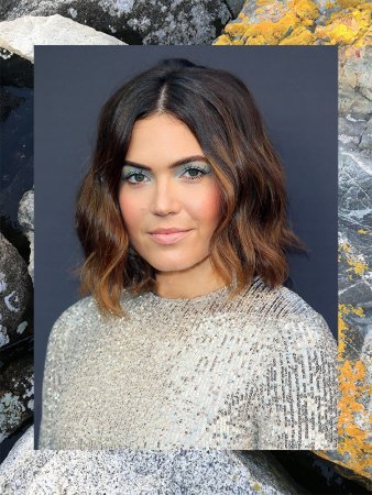 portrait of mandy moore in a sequin dress against a metallic background