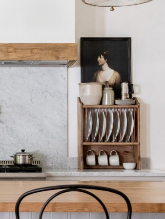 farmhouse kitchen with plate rack next to the range