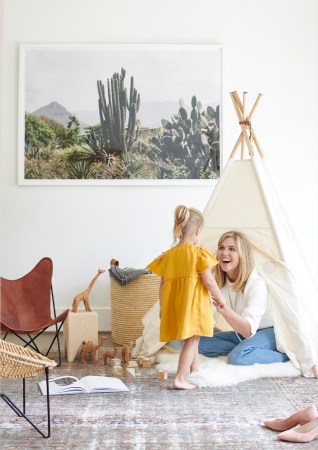 carly nance sitting in a tepee looking at her daughter