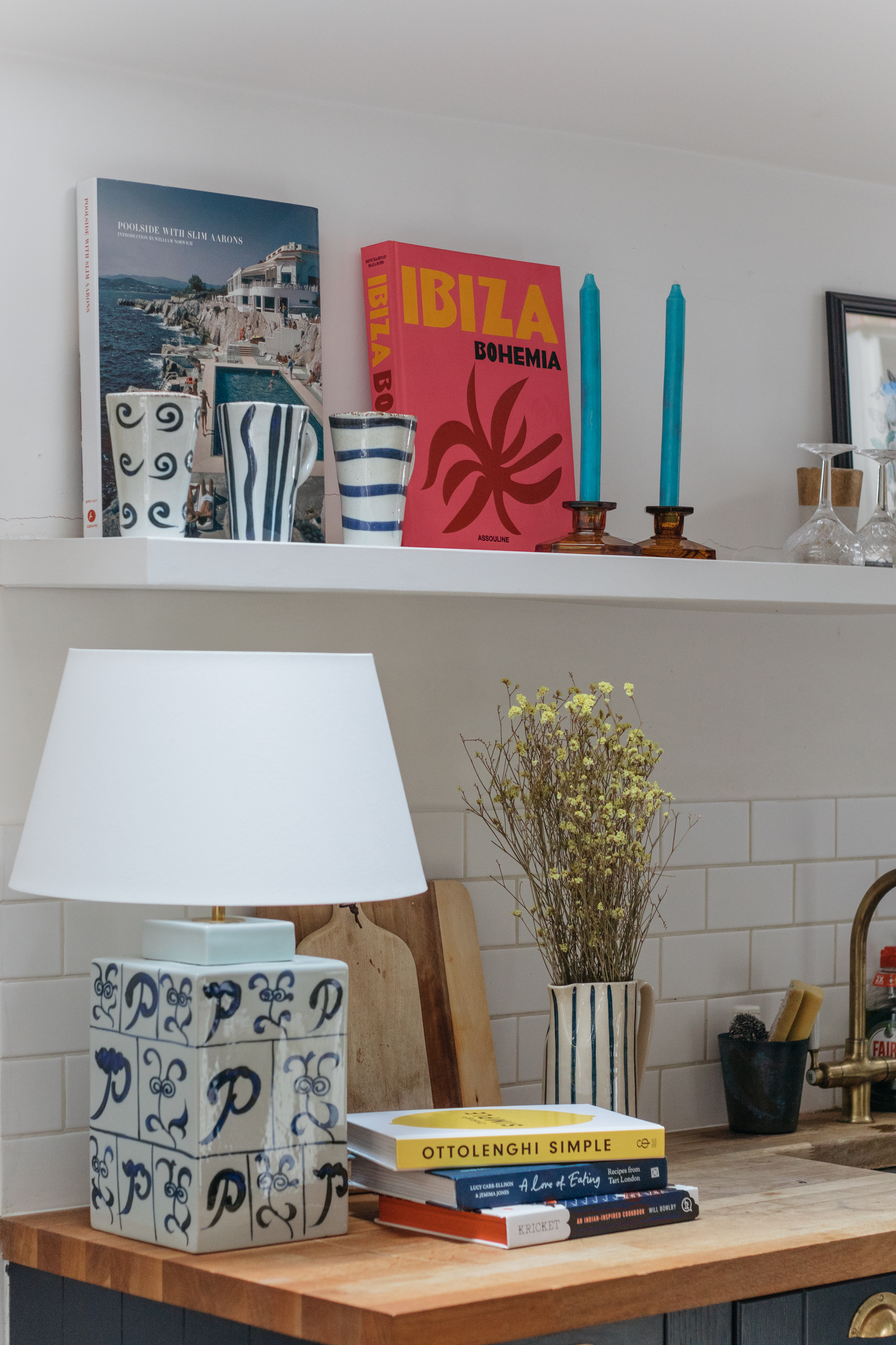 blue and white lamp sitting on a butcher block counter