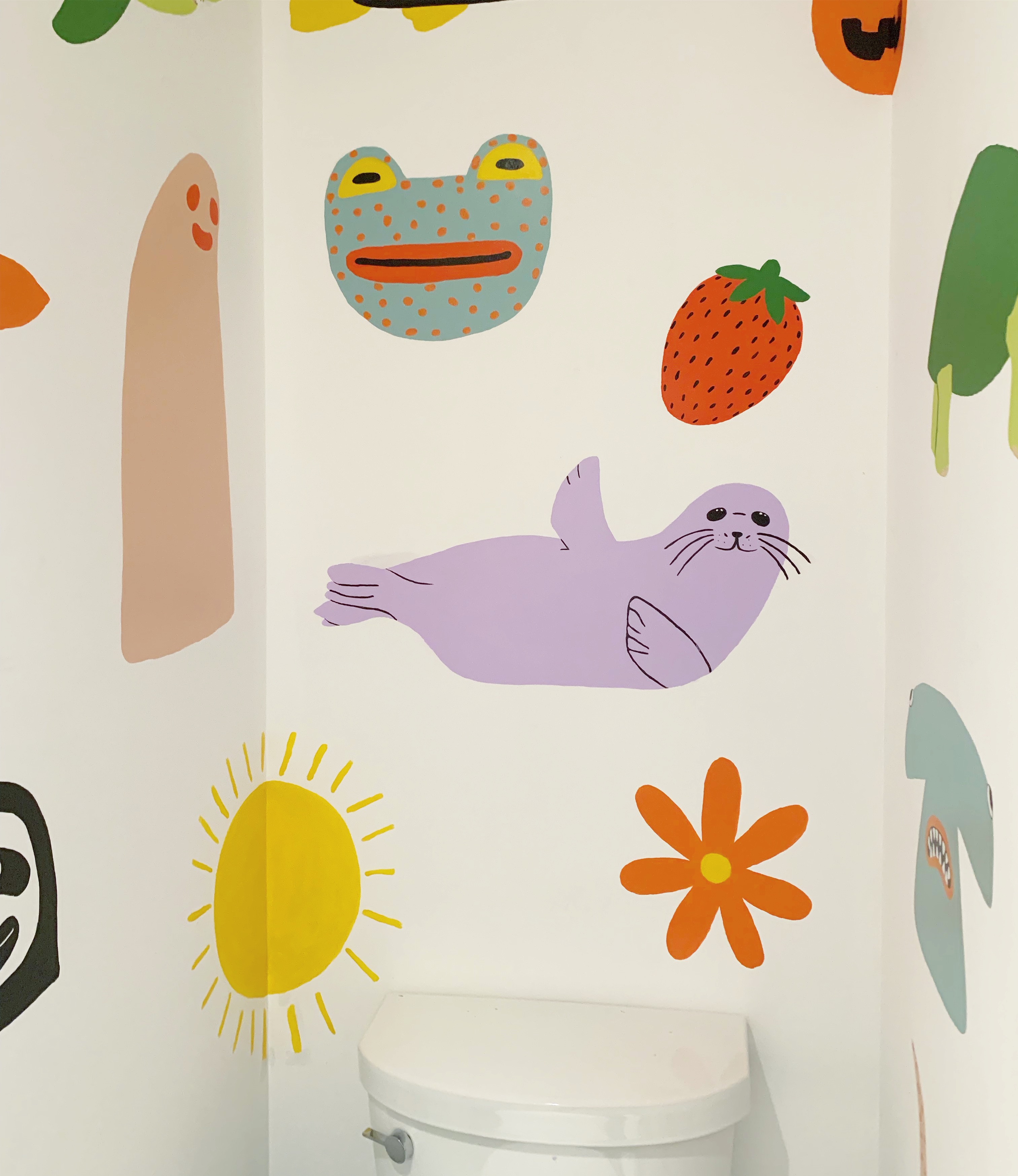 bathroom with purple seal and green frog and other shapes