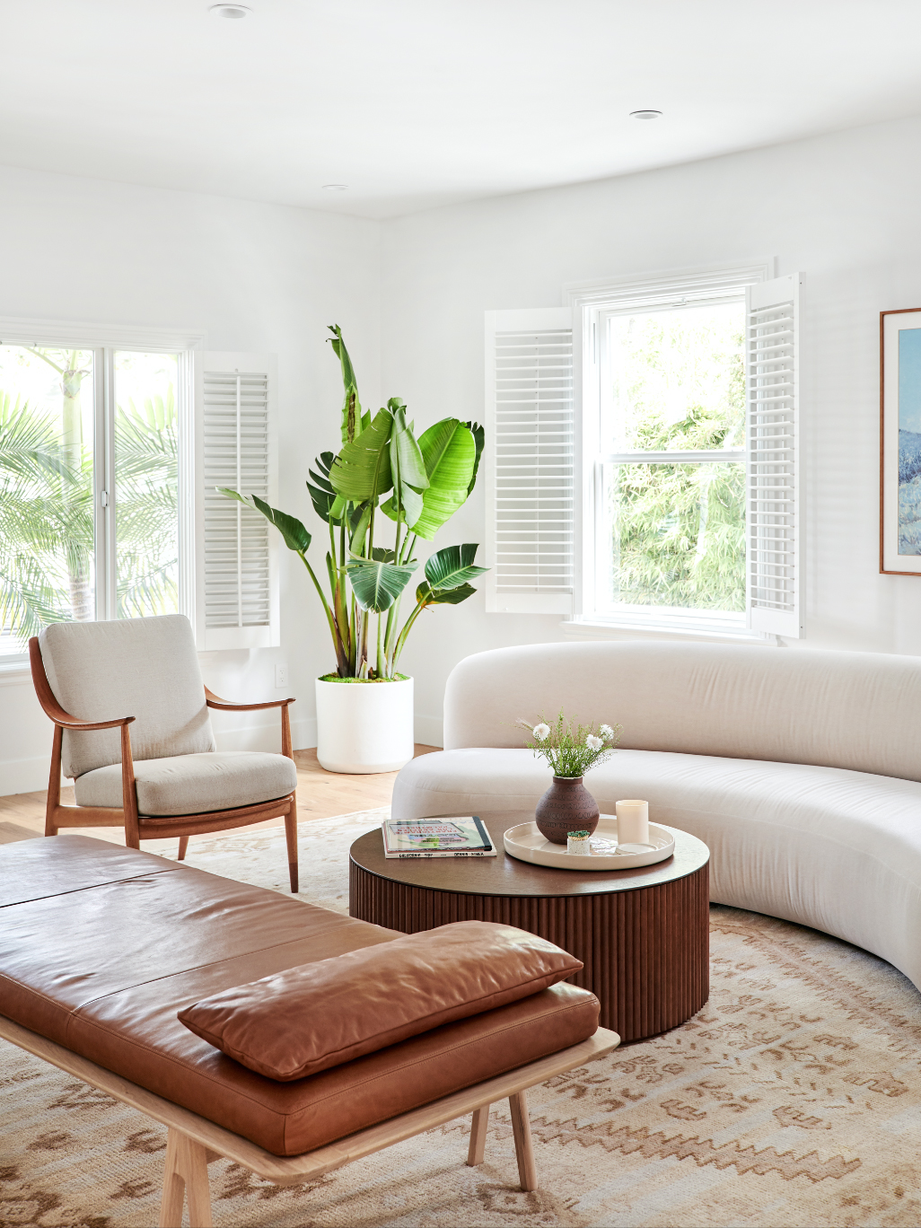 leather daybed in a sitting room with a curved sofa