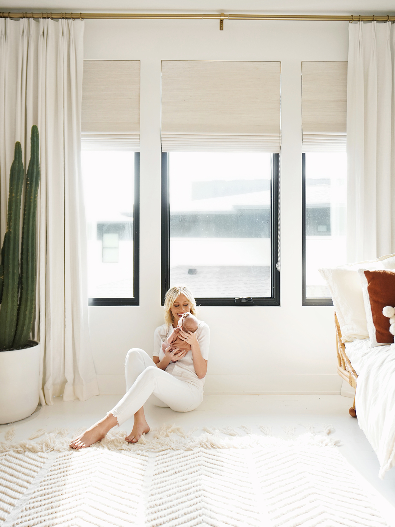 mary lawless lee sitting on the floor holding her baby