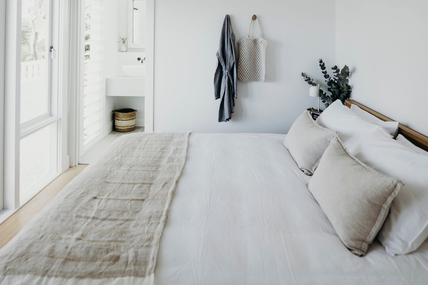 White bedroom with white bedding. 