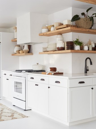 white kitchen with wood shelves