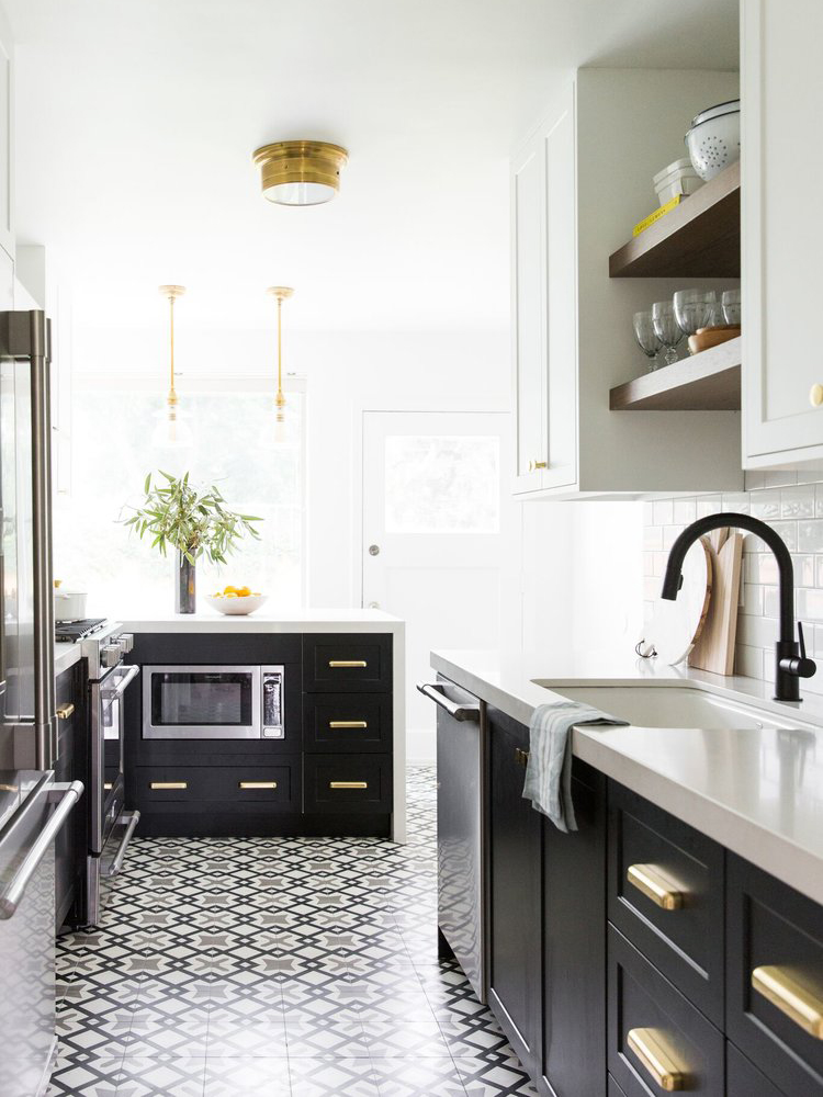 black white and brass kitchen with mosaic floor tiles