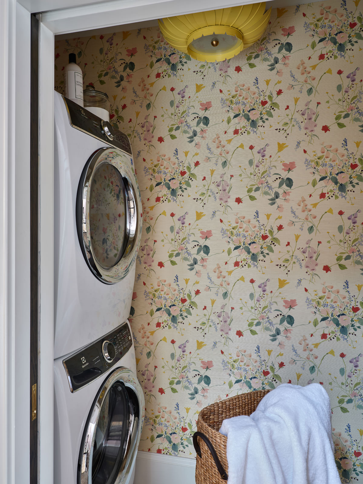 floral wallpaper with washer and dryer stacked to the side wall