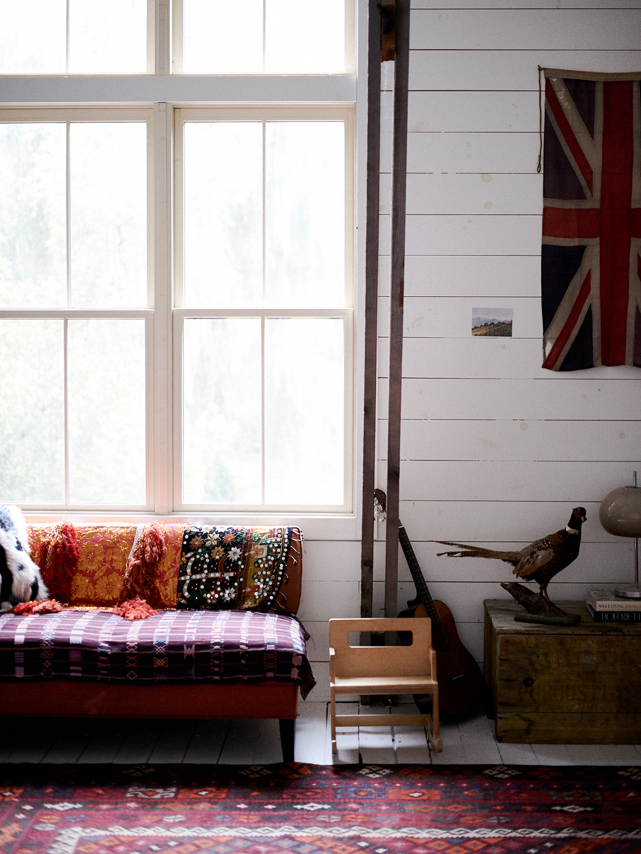 restored farmhous eliving room with a purple and fringe sofa blanket