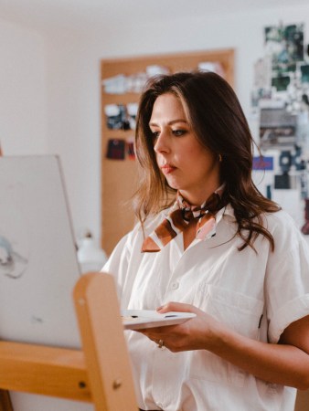 portrait of artist painting in her studio