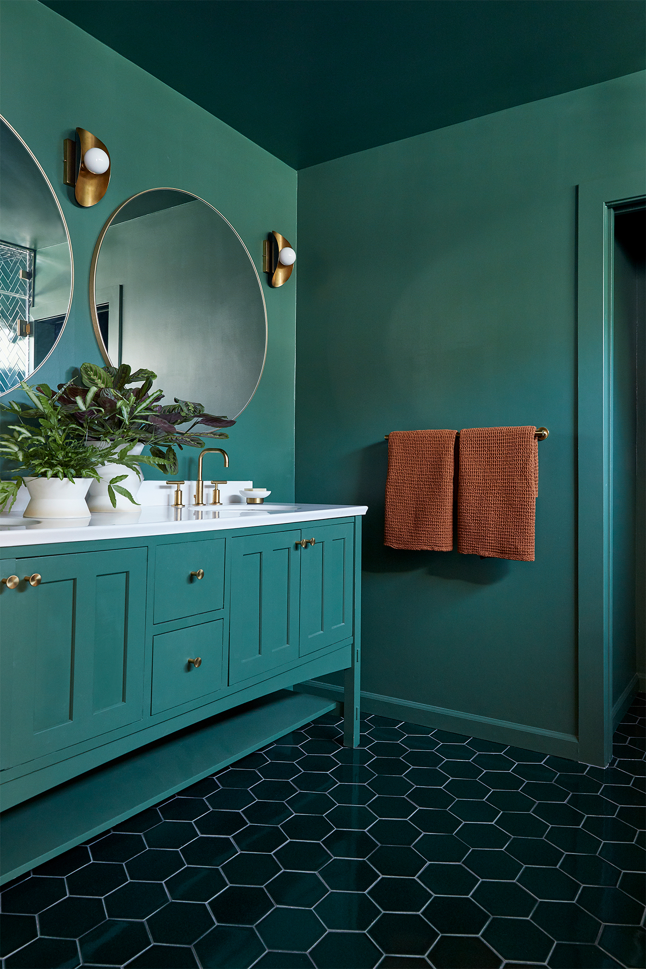 round mirror and a green vanity