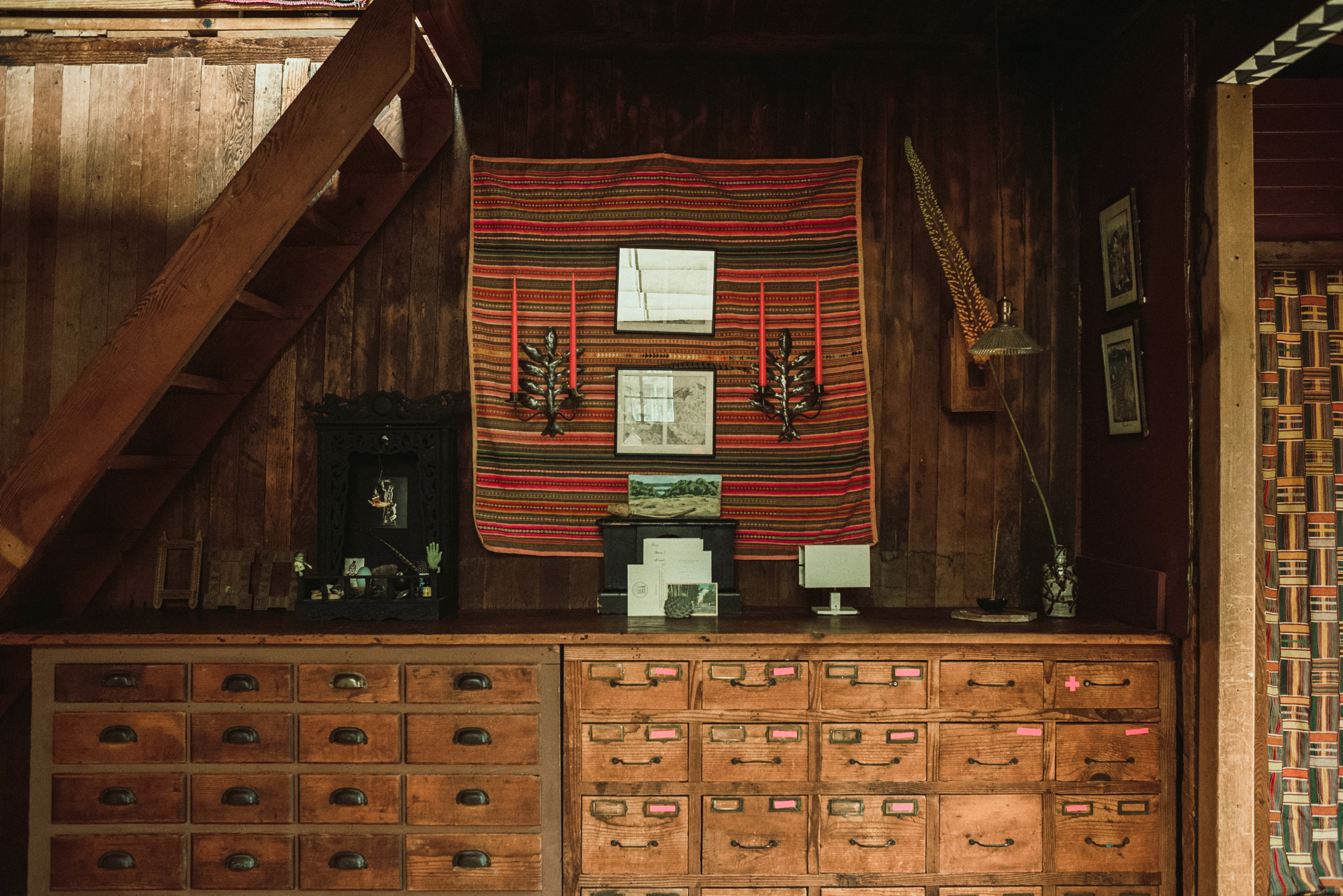 wood cabin with red texilte on wall