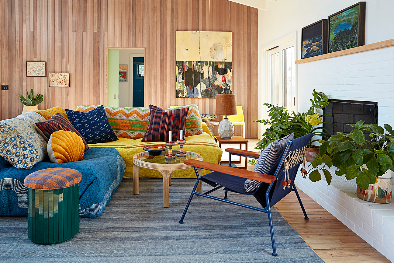 sectional sofa covered in colorful blankets