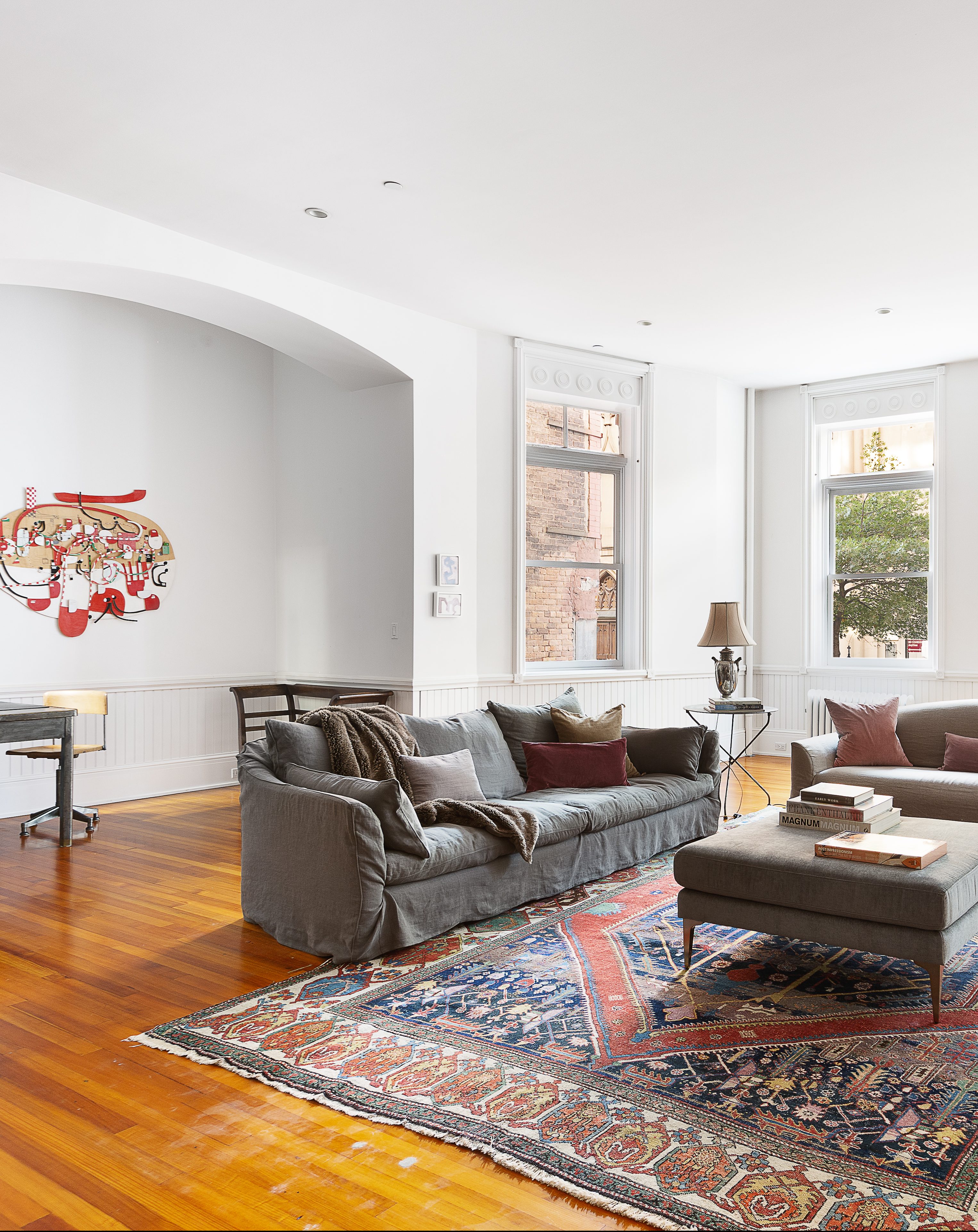 white living room with traditional oriental rug