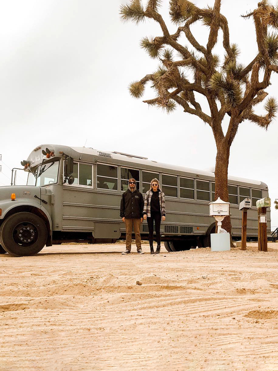 Couple in front of school bus