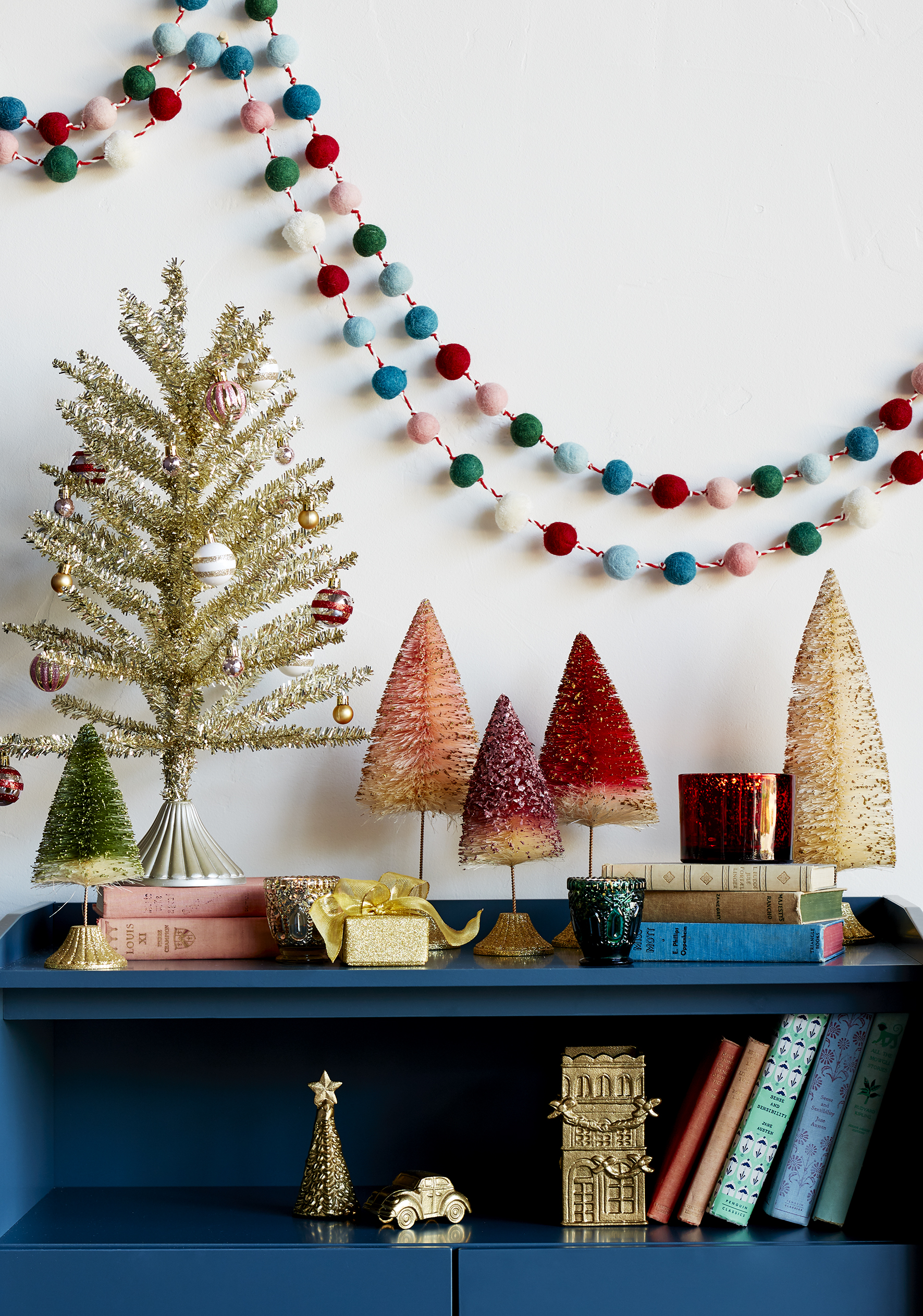 blue-bookshelf-colorful-christmas-decorations