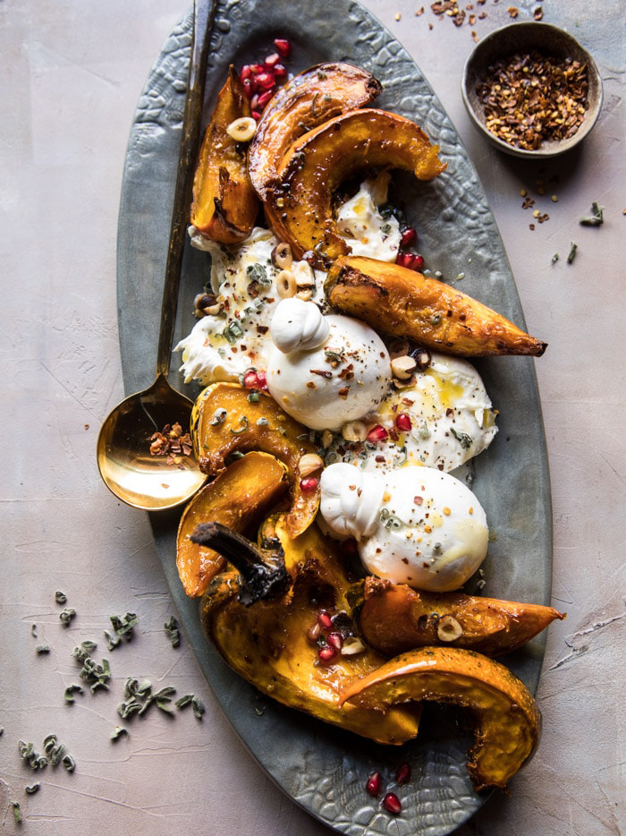 Acorn squash with burrata, hazelnuts, and pomegranate seeds.