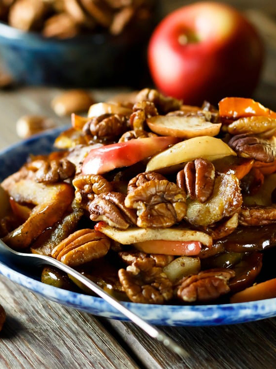 Plate with acorn squash slices, apple slices, and pecans.