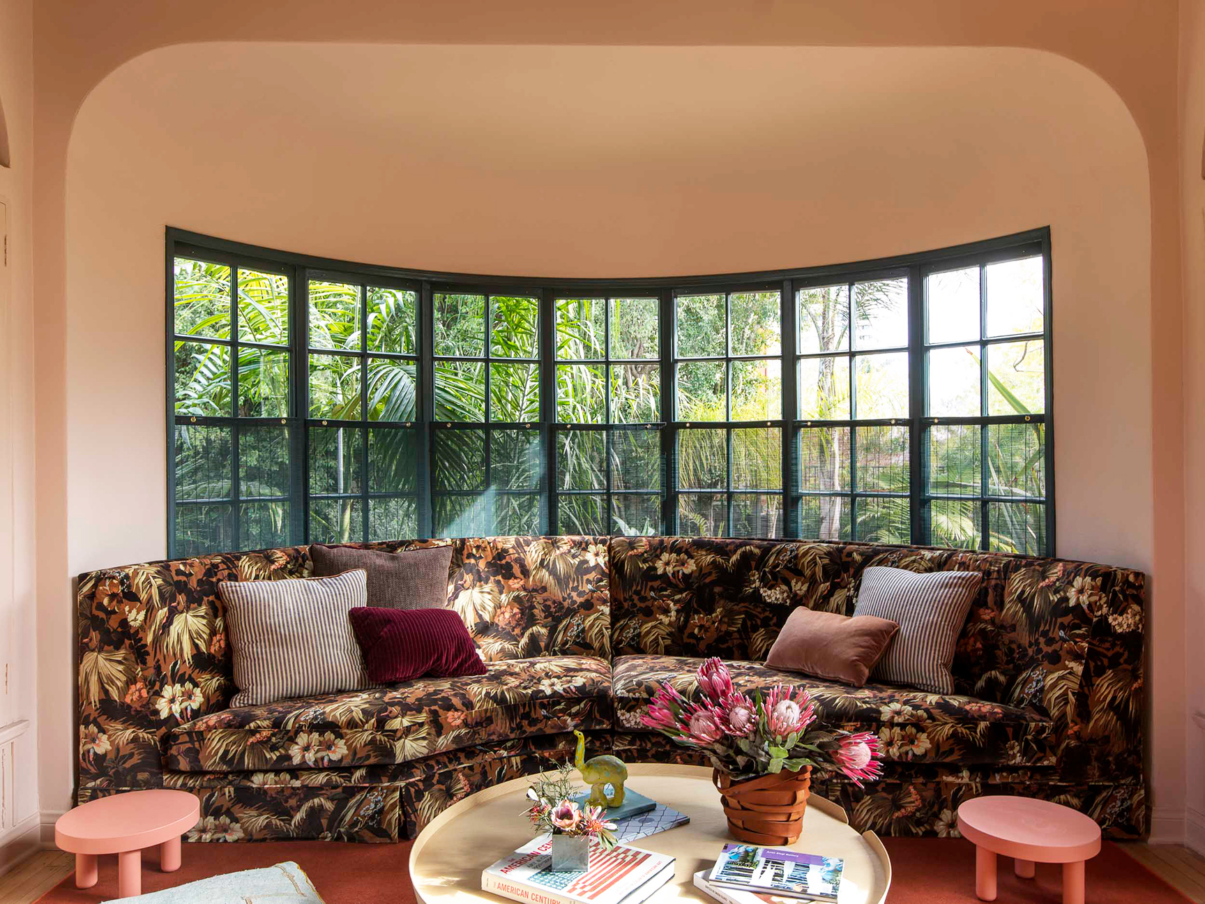 Curved floral velvet sofa in pink room