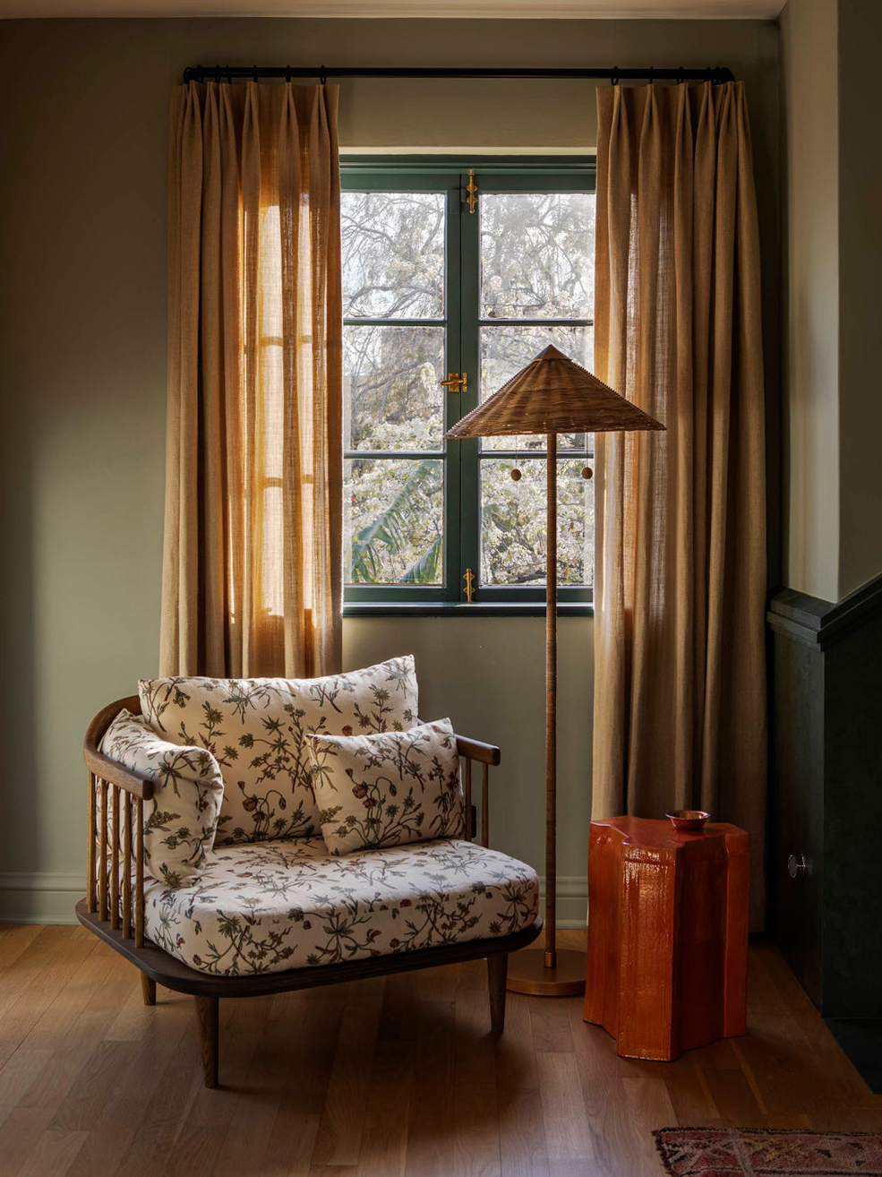 Green room with rattan floor lamp and chair