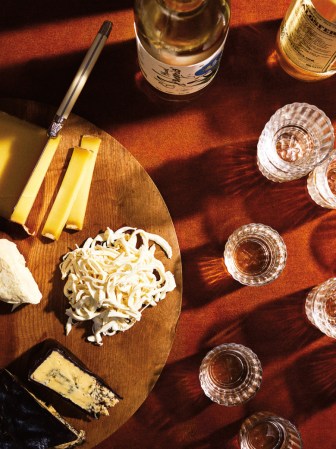 Table with cheeseboard and glasses.