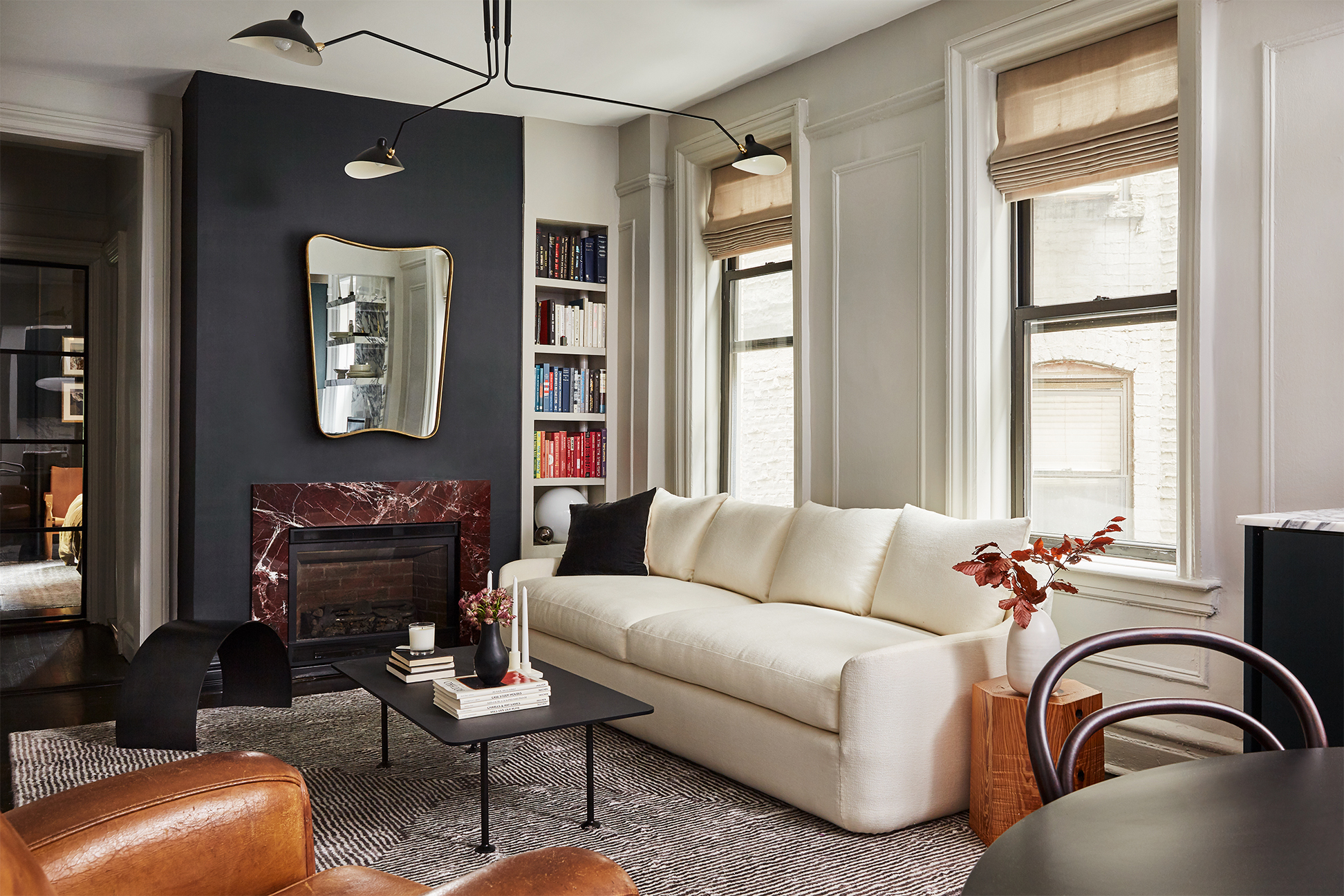 Small living room with white sofa and red marble fireplace