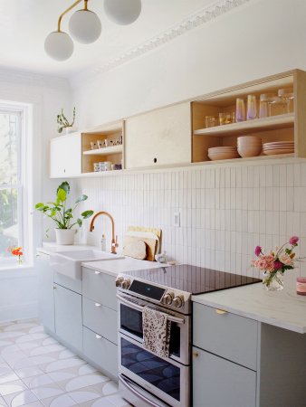 bright kitchen with green lower cabinets