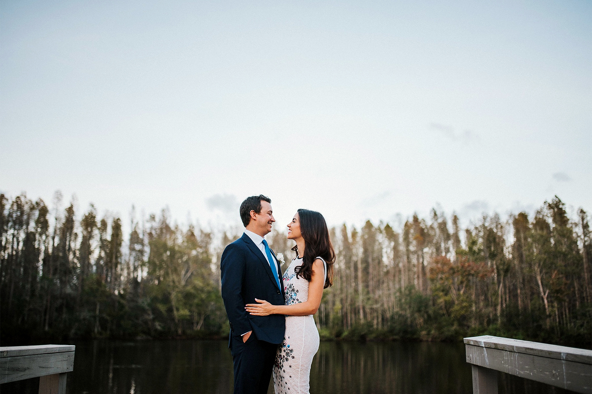 Couple by a lake on their wedding day