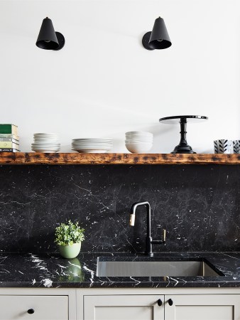 Kitchen with black countertops and backsplash