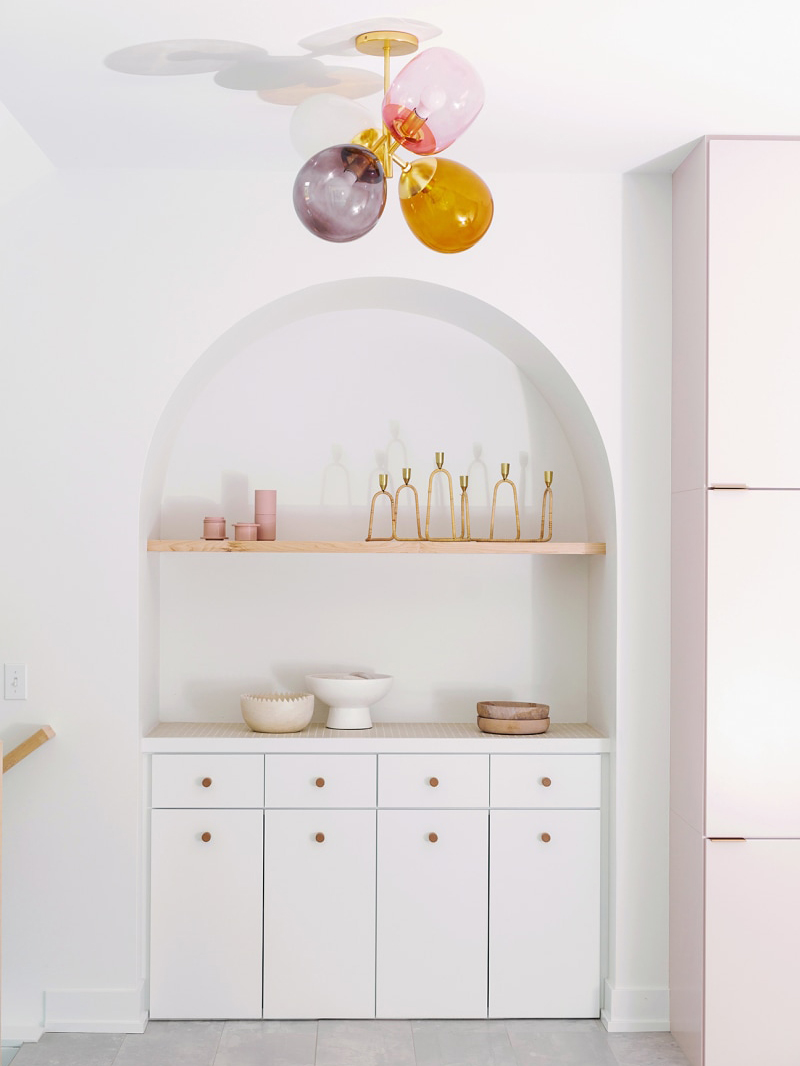 archway alcove with shelves and white cabients