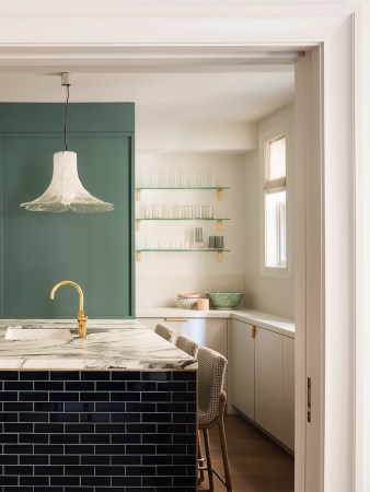 white kitchen with green accent wall