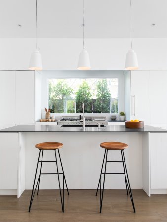 White kitchen with wooden bar stools