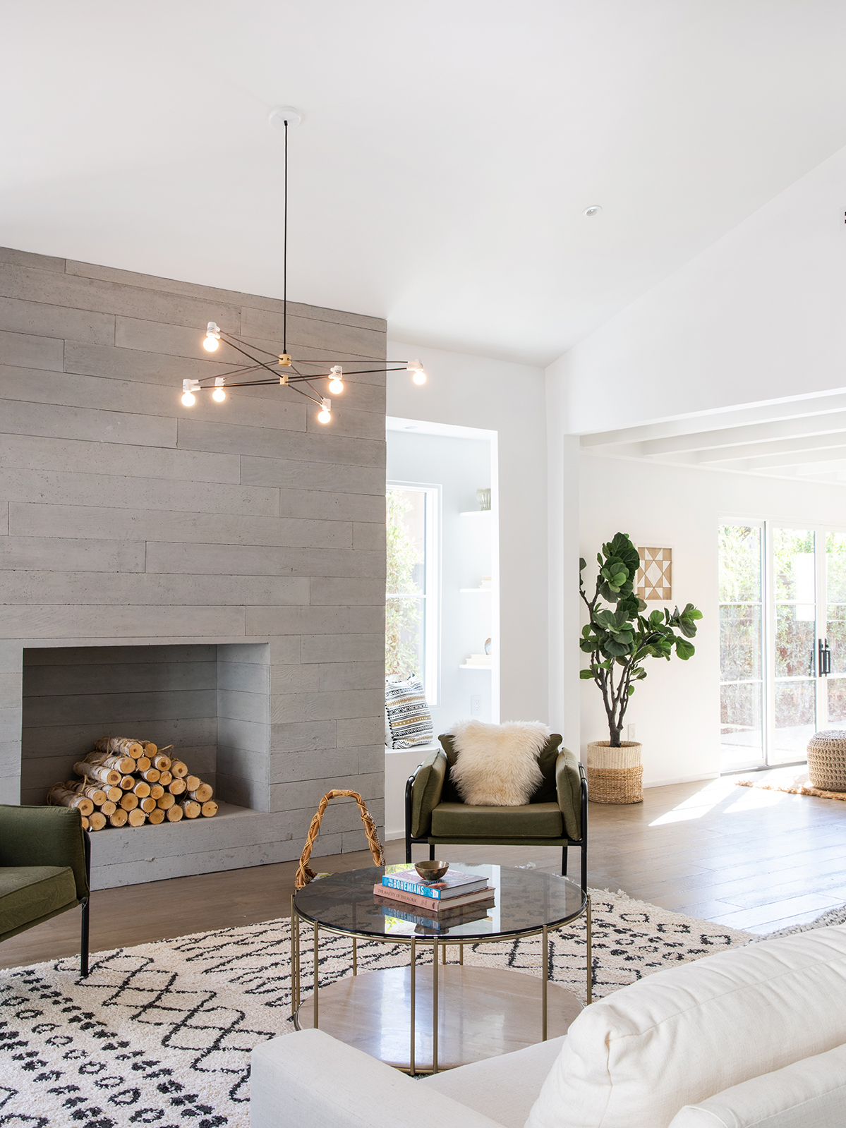 minimalist living room with grey stone fireplace