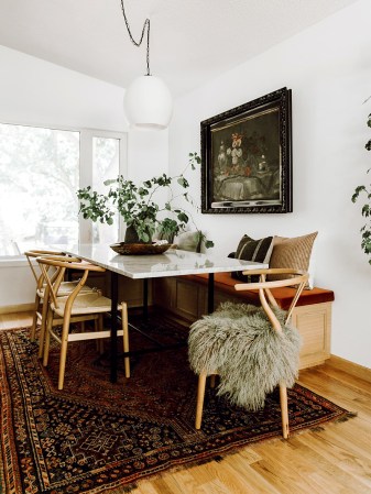 dining room nook wiht built in bench and large white globe pendant