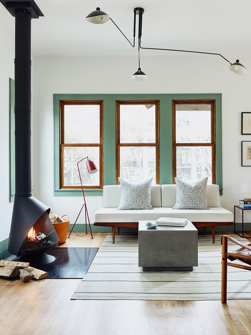 White bungalow living room with green windows