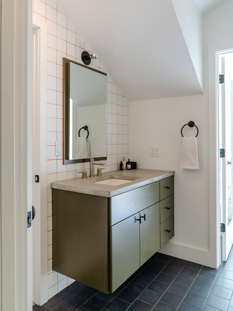 Bathroom with white tile and red grout