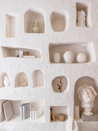 wall niches filled with vases and sculptures