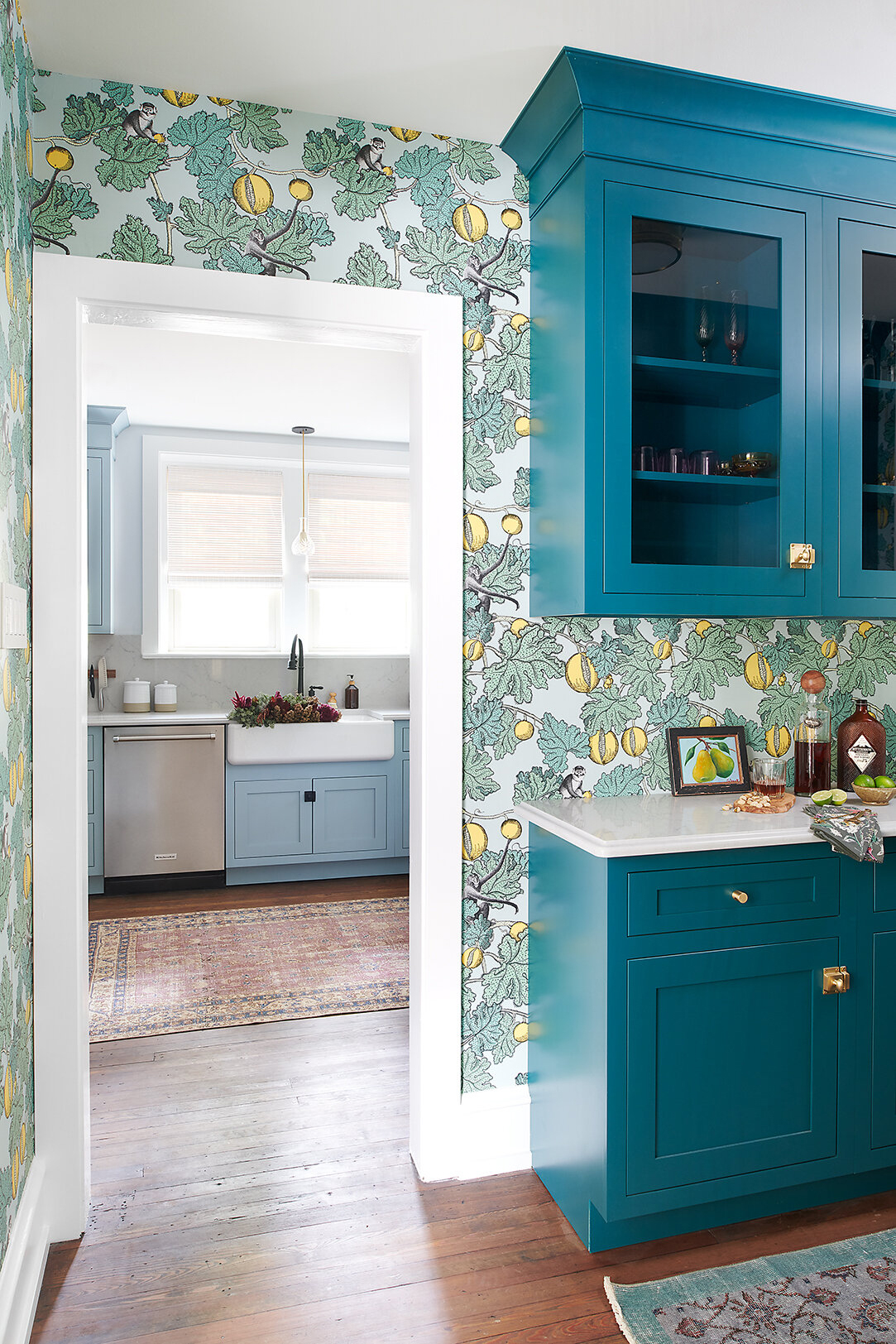 Teal pantry with fruit wallpaper