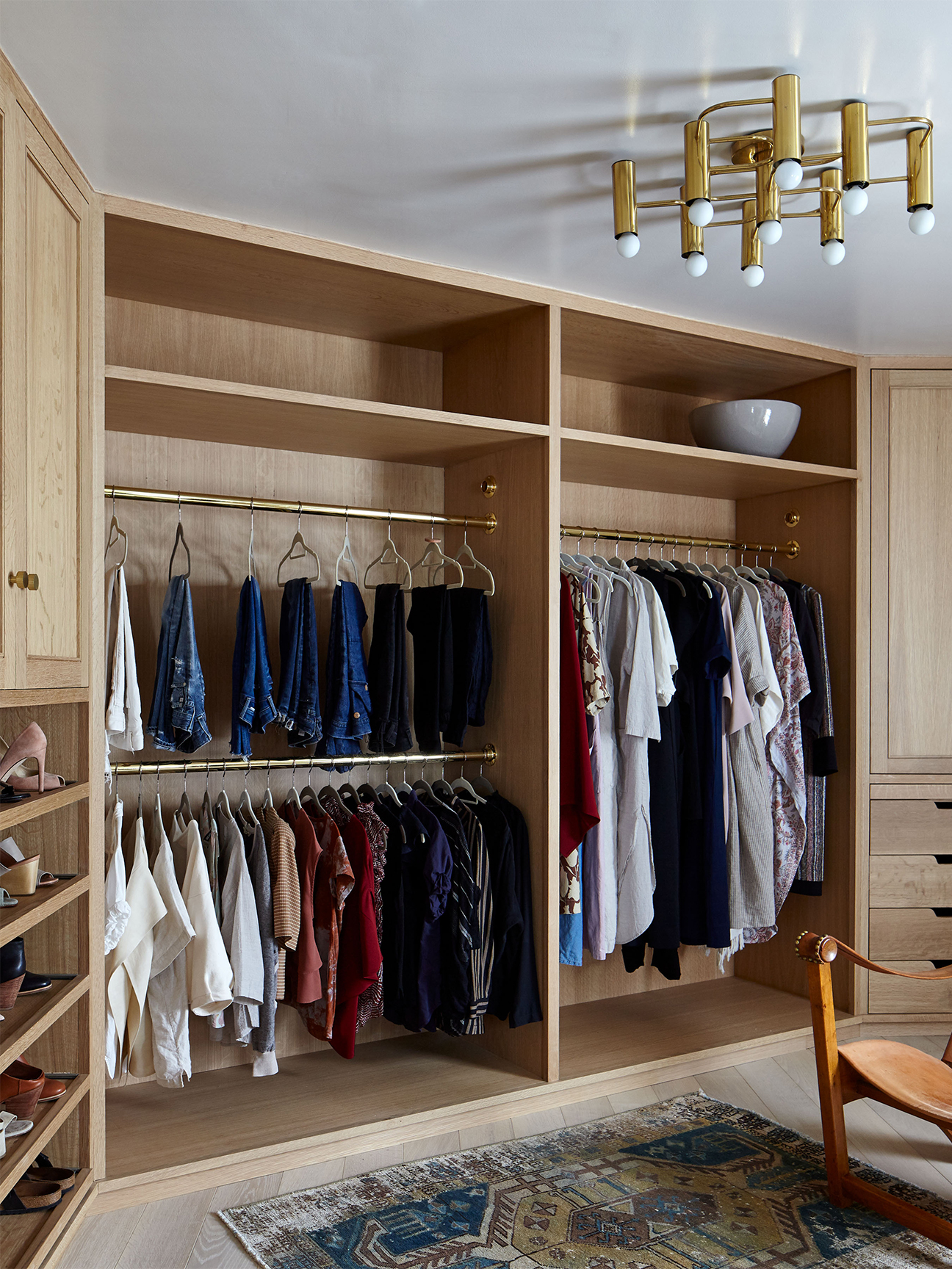 Walk-in closet with brass and oak finishes