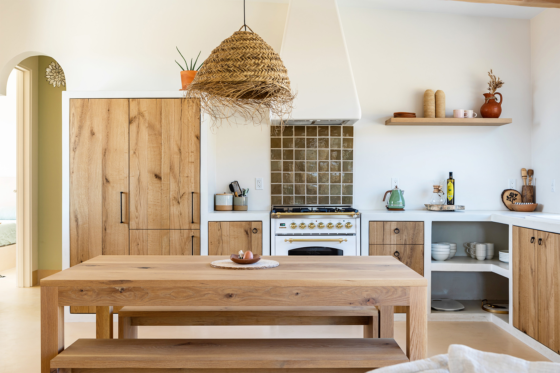 Joshua tree kitchen with plaster countertops and wood cabinets