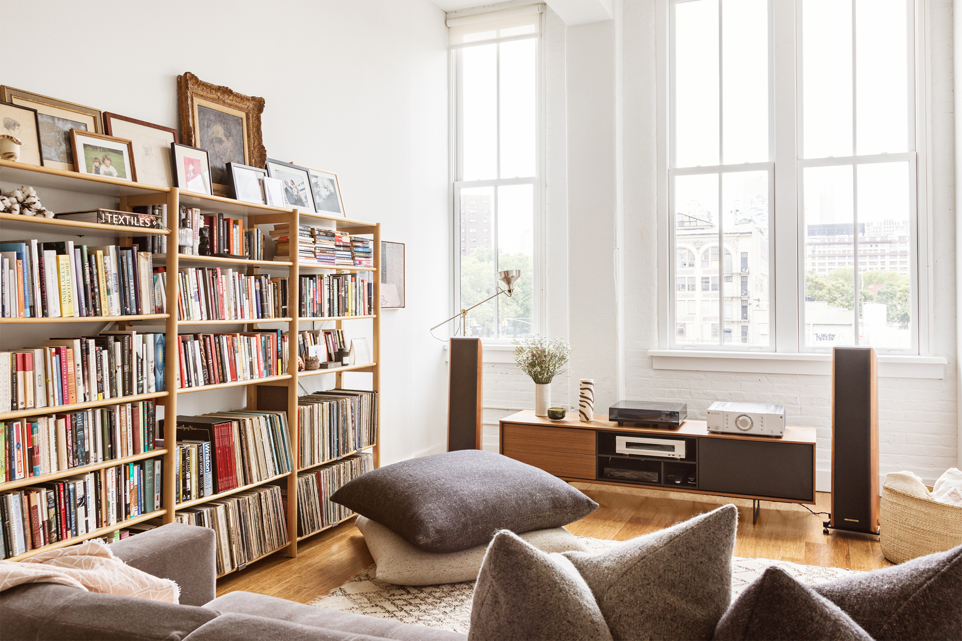 Small living room with floor pillows and bookcase