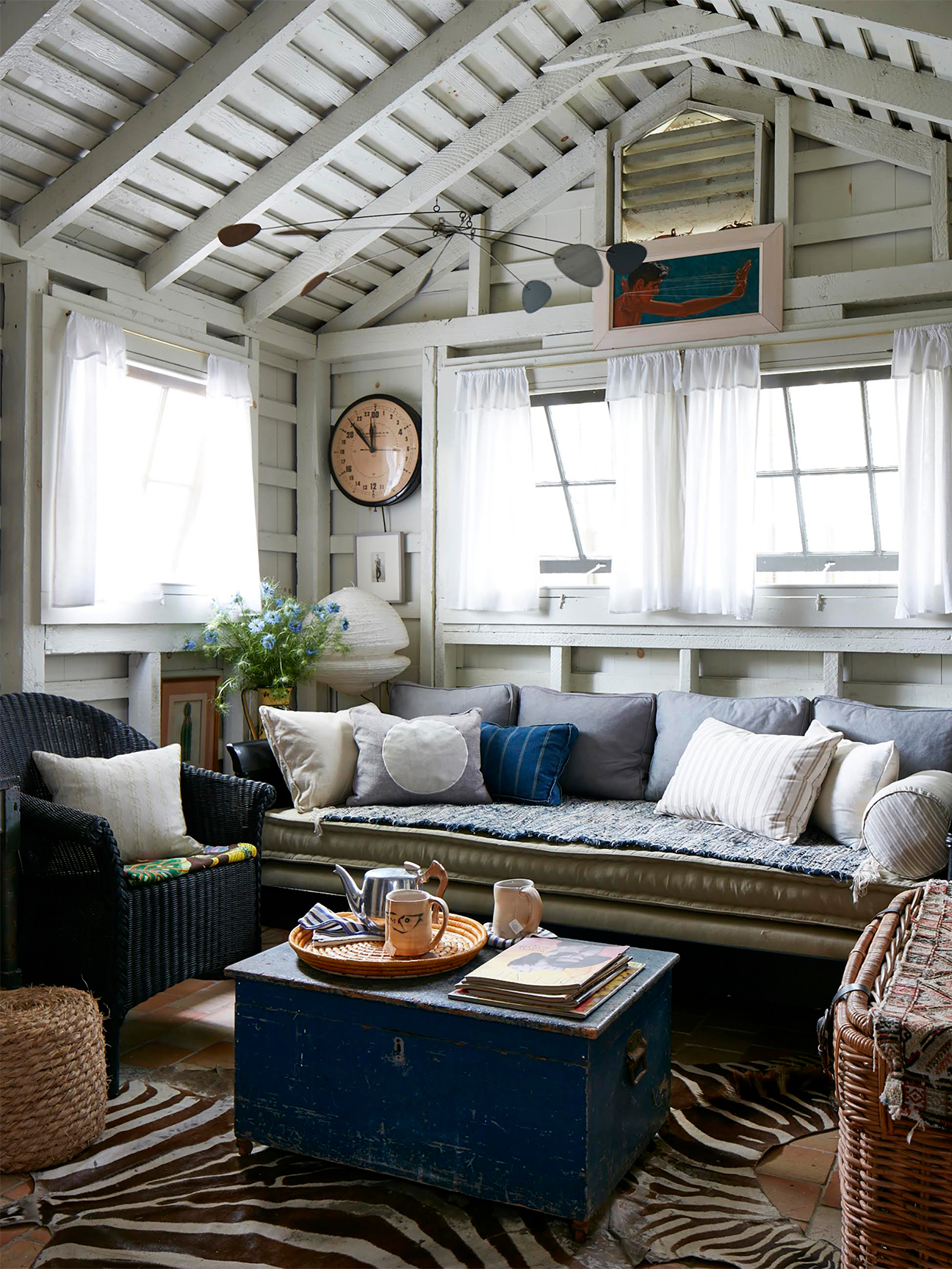 Small living room with pitched roof and multiple pillows