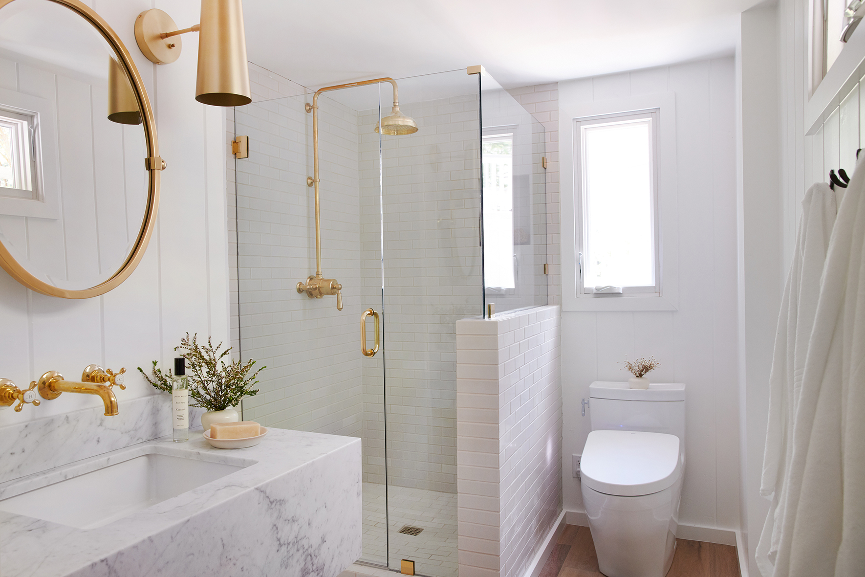 Bathroom with white marble sink and glass shower