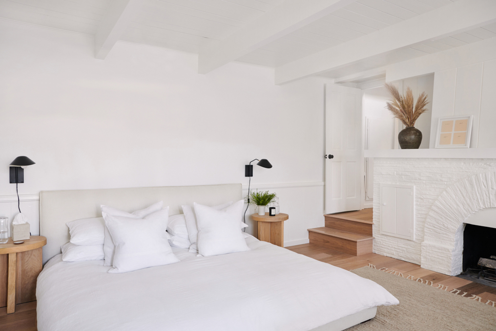 All white bedroom with fireplace