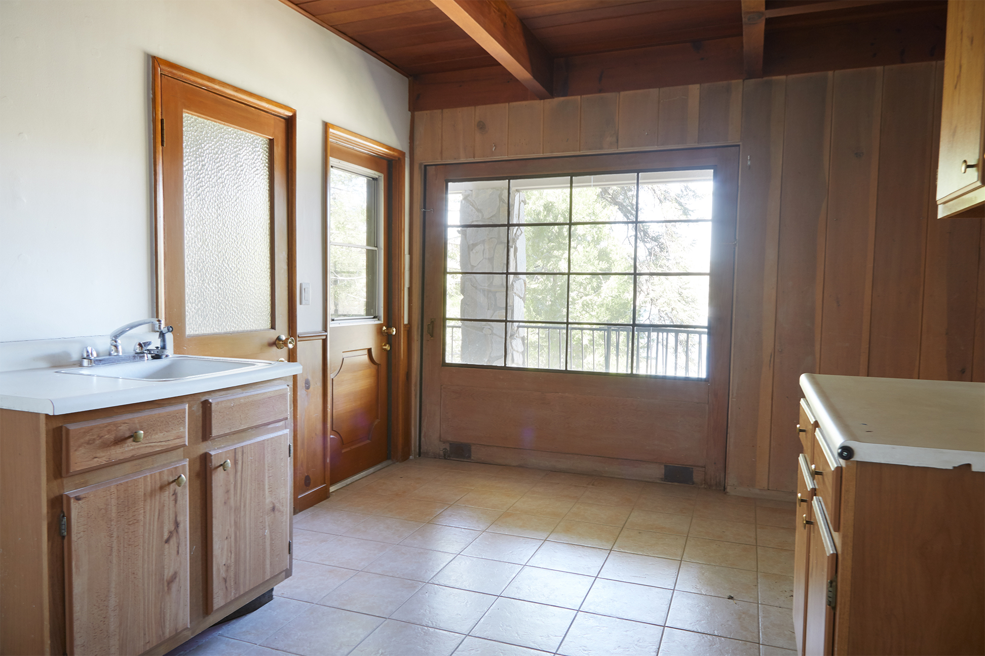 Dated laundry room with pocked door