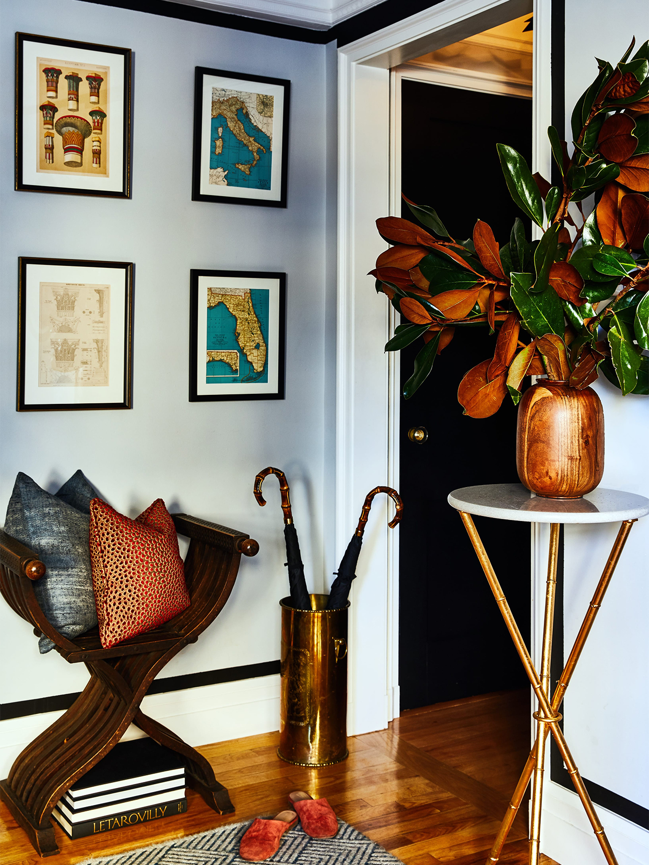 Entryway with black-painted door and umbrella holder