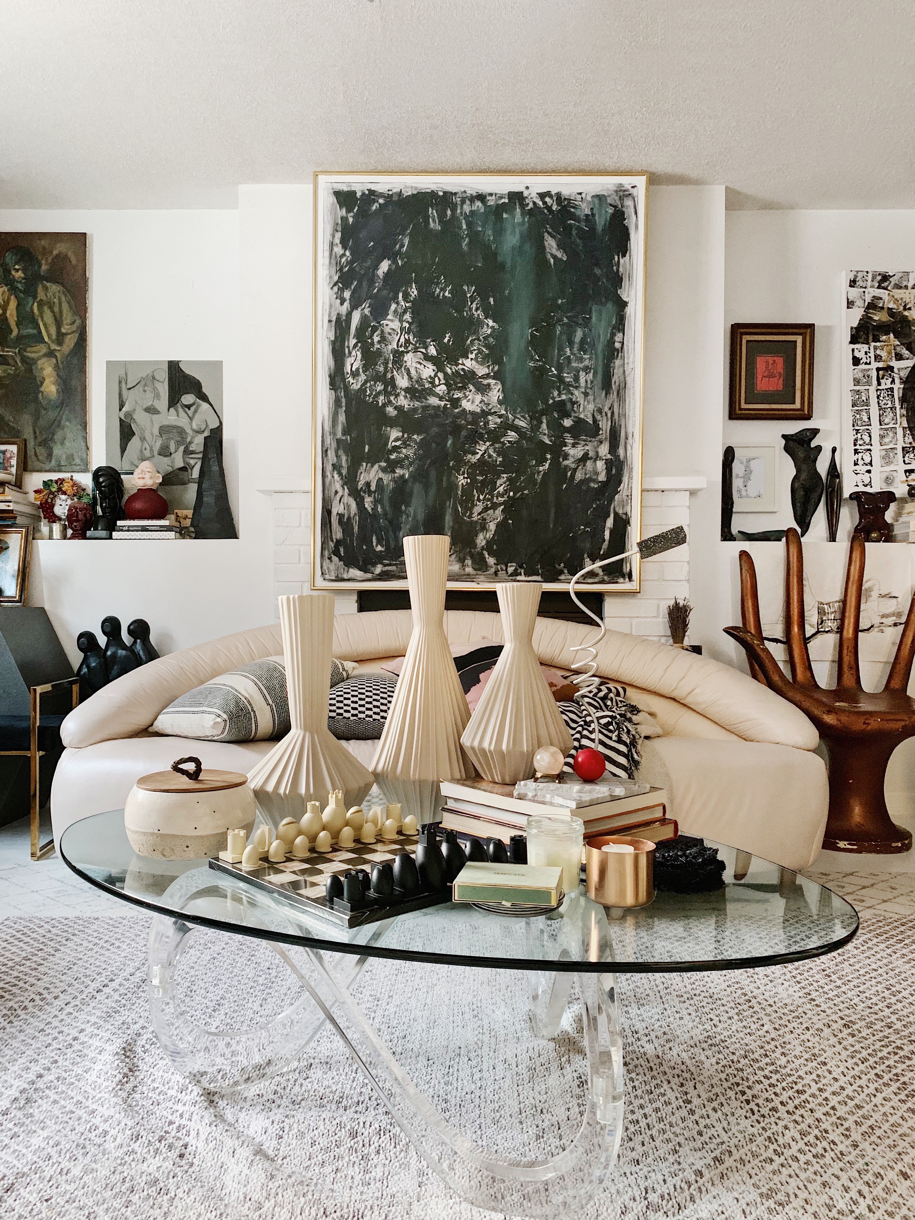 white retro sofa with glass coffee table with a lot of vases