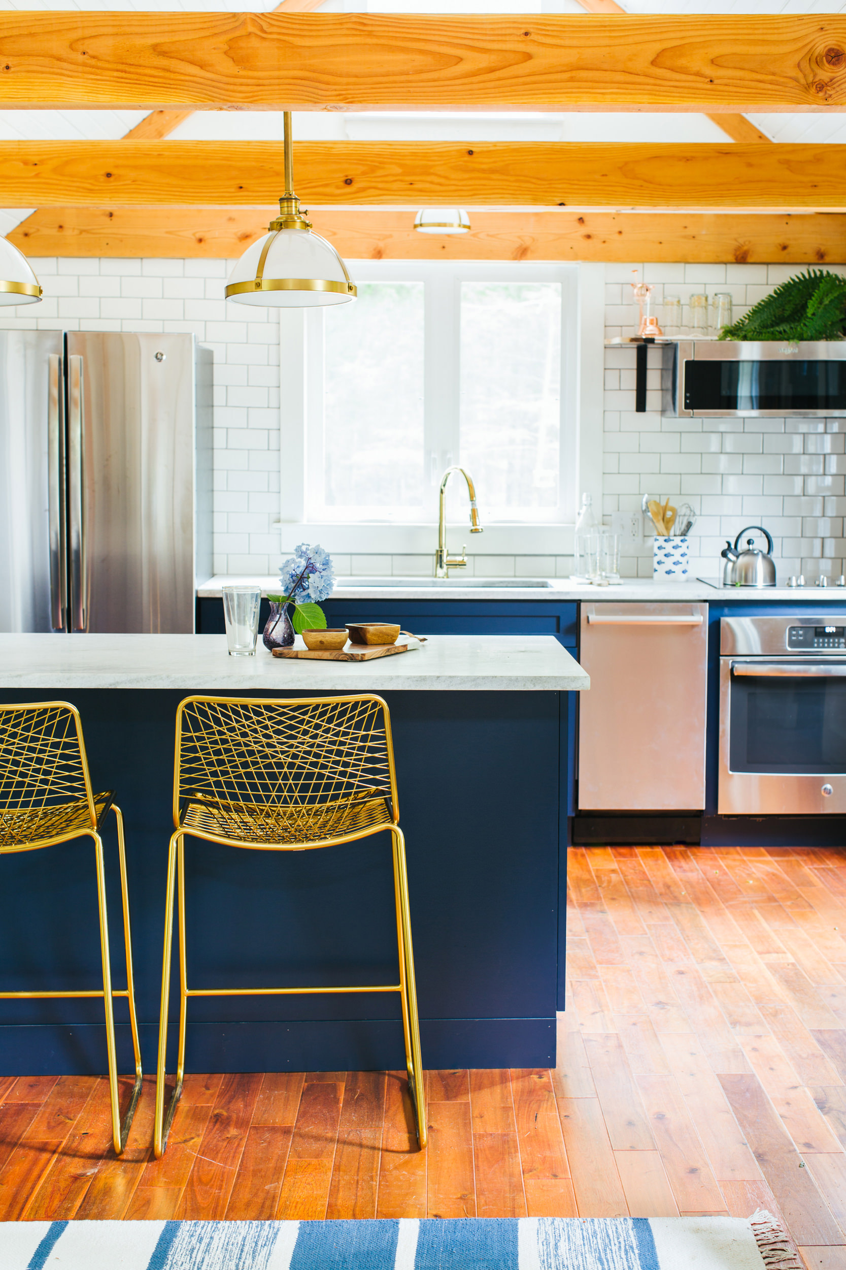 blue kitchen with wood beams on the ceiling