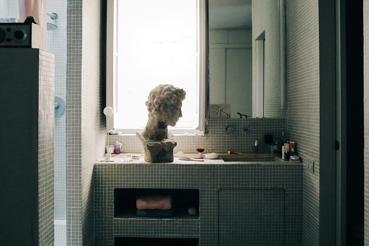 bathroom sink with marble bust sitting on top