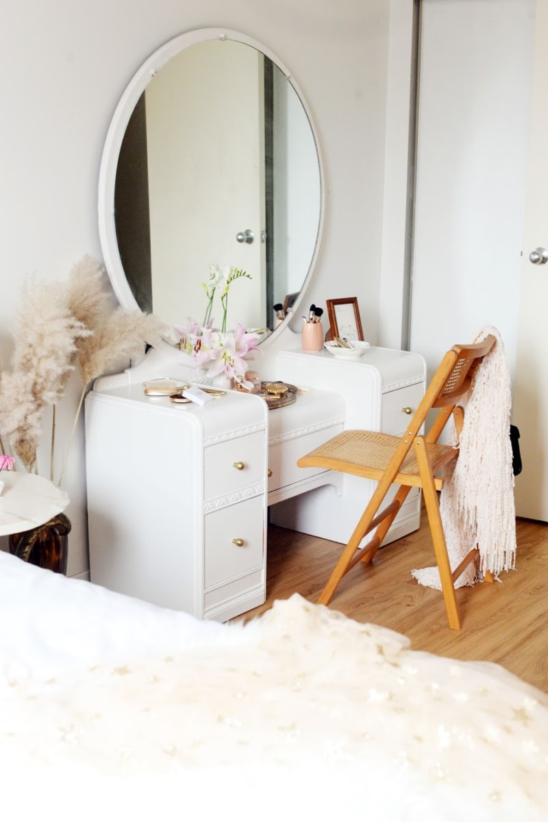 bedroom vanity with mirror and cane chair