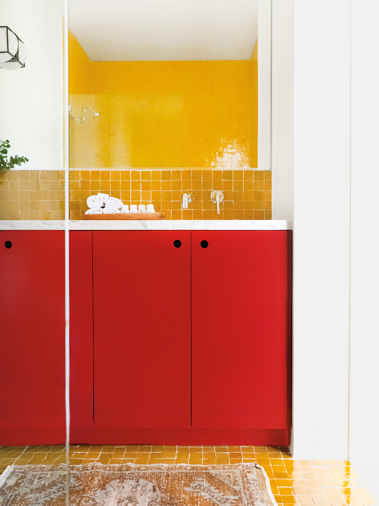 Bathroom with yellow tile and red vanity